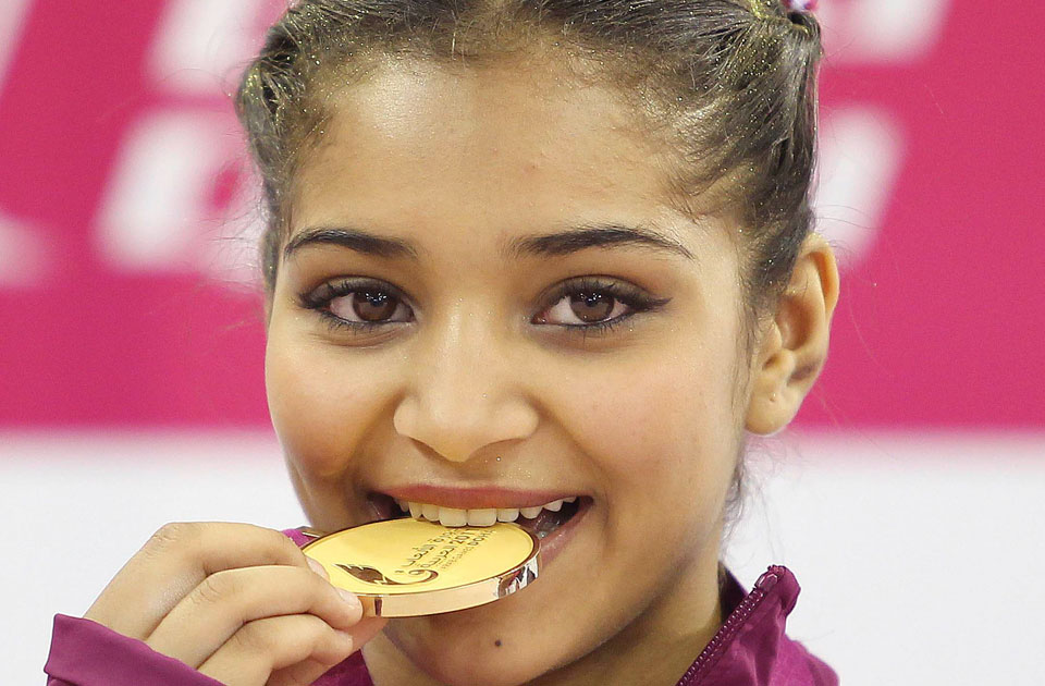 Fatima Abdulla of Qatar bites her medal after the trampoline gymnastics women&#39;s individual final at - 2011-634600942858671481-867