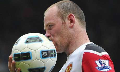 Wayne Rooney kisses the ball following a 42 victory over West Ham Phot