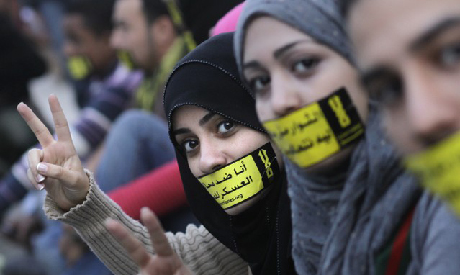File photo of Egyptian activists with stickers that read: "No to military trials for civilians" at a