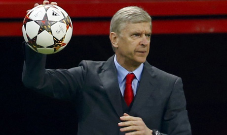 Arsenal's manager Arsene Wenger hands the ball to players during their ...