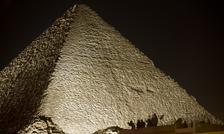 Visitors film the light on the historical site of Giza            Pyramids as they celebrate the New Year in Eg