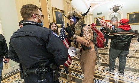 Supporters of Trump are confronted by Capitol Police officers outside the Senate Chamber inside the 