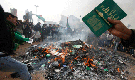 demonstrators burn copies of the Green Book