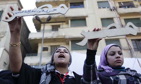Egyptian protesters hold words which read 