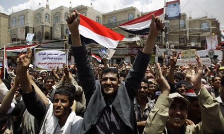 Anti-government protesters shout slogans during a rally to demand the ouster of Yemen