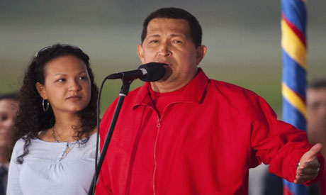 Chavez speaks next to his daughter before his departure to Cuba (Reuters photo)