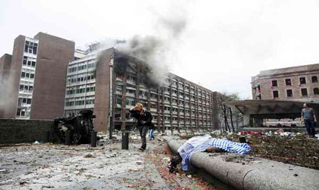 People walk at the site of a powerful explosion that rocked central Oslo (Reuters photo)