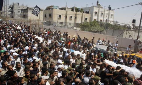 Palestinian mourners carry the bodies of four of the five Popular Resistance Committee militants kil