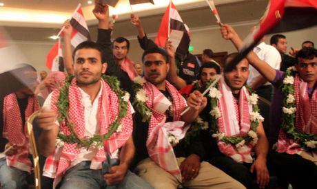 The 25 Egyptian detainees, released by Israel, wave national flags during a welcoming ceremony after
