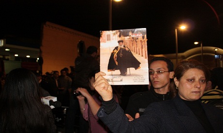 Egyptian Coptic lady holds Pope Shenouda