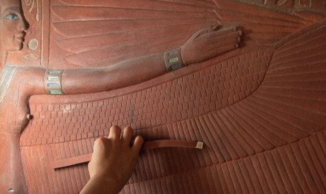 Artist puts final touches to one of the tomb