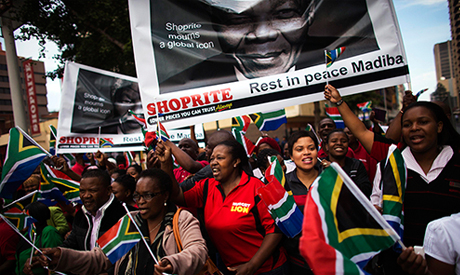 People sing and dance before the cortege carrying the coffin of former South African President Nelso