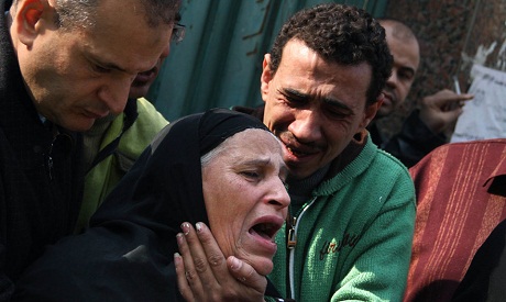 Unidentified relatives mourn slain Egyptian protesters who were killed during the latest clashes (Ph