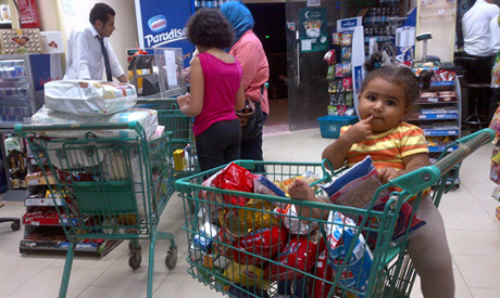 A family buys groceries at a market