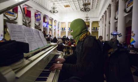 masked man plays the grand piano