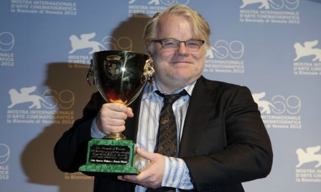 Philip Seymour Hoffman holding the Coppa Volpi for Best Actor for his role in 