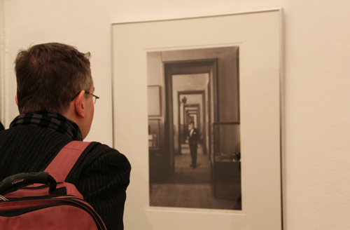 Visitor inspects artwork at The House of Rare Historic Photographs exhibition, Townhouse Gallery. (P