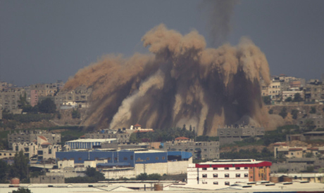 Smoke and debris rise after an Israeli strike on the Gaza