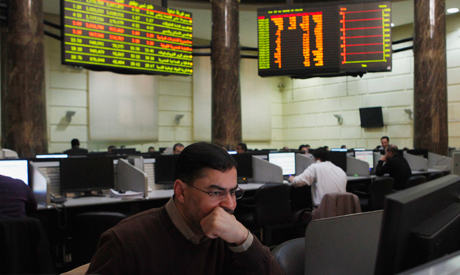 Traders work at the Egyptian stock exchange