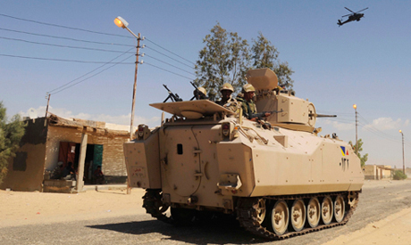 Egyptian Army soldiers patrol in an armored vehicle