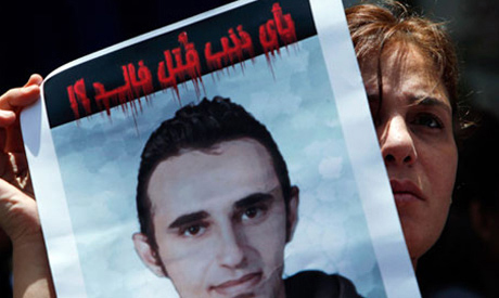 An activist carries a picture of slain Khaled Said