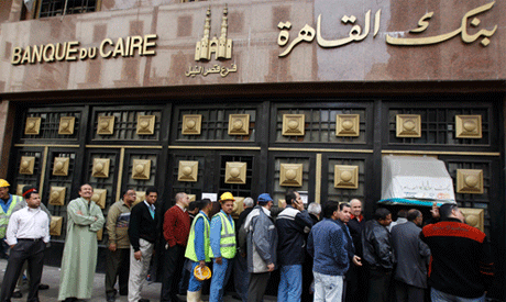 People stand in the line to make withdrawals outside Cairo Bank in downtown Cairo (Reuters)