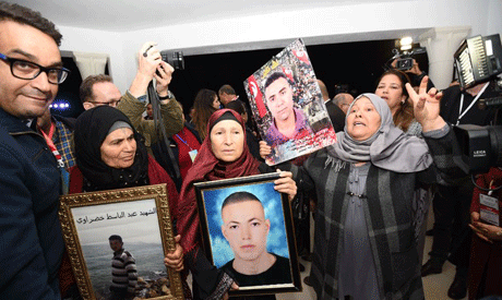 Mothers of torture victims carried their sons’ portraits before the Truth and Dignity Commission hea