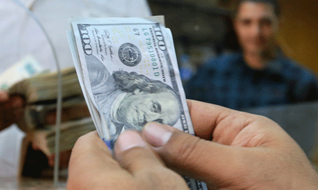 An employee counts U.S. dollars in a foreign exchange office in central Cairo, Egypt (Reuters)	