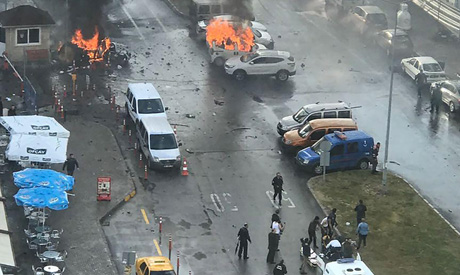 Cars burn in the street at the site of an explosion in front of the courthouse in Izmir on January 5
