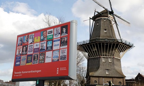Dutch Campaign posters are seen in front of a windmill in Amsterdam, the Netherlands, March 1 2017 (