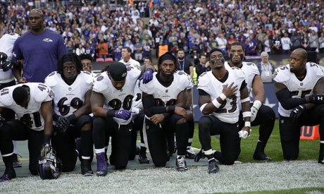 Baltimore Ravens players kneel