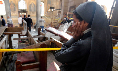 A nun cries at the scene of the bombing inside Cairo