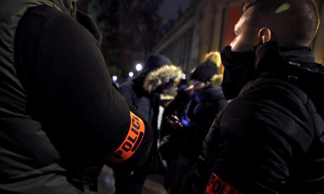 Masked police officers attend a demonstration near the Champs-Elysee in Paris, France, December 20, 