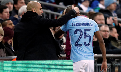 Manchester City manager Pep Guardiola consoles Fernandinho as he leaves the pitch after sustaining a
