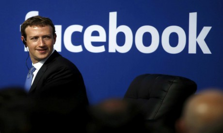 Facebook CEO Mark Zuckerberg is seen on stage during a town hall at Facebook