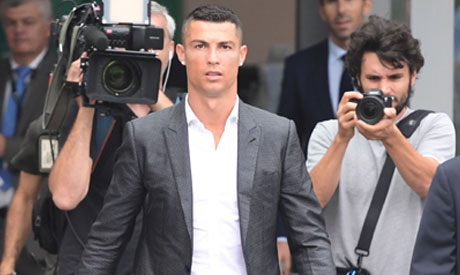 Portuguese footballer Cristiano Ronaldo (C) arrives on July 16, at the Juventus medical center at th