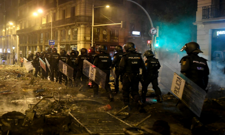 Policemen walk over debris in Barcelona