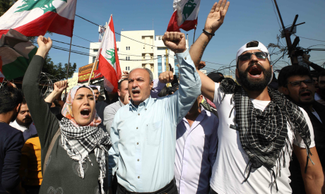 Lebanese demonstrators wave the national flag as they chant during an anti-American protest near the
