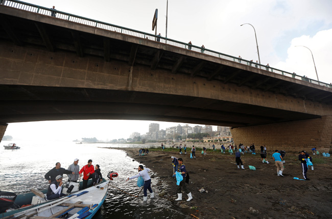 Egyptian youth volunteers collect waste and plastic as part of a campaign to clean up the Nile River