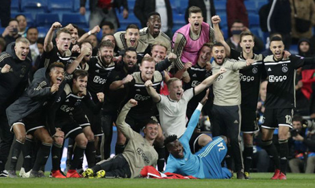 Ajax players celebrate after wining the game, at the end of the Champions League soccer match betwee