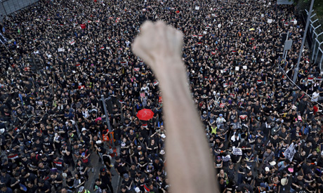 protesters march on the streets against an extradition bill in Hong Kong. (AP)