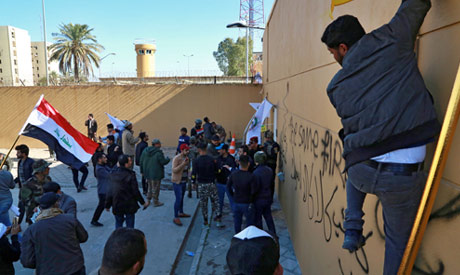 Iran-backed Popular Mobilization Forces and their supporters try to break into the U.S. embassy, in 