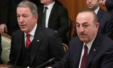 Turkish Foreign Minister Mevlut Cavusoglu (R) and Defence Minister Hulusi Akar (L) attend a meeting 