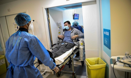 Paramedics carry on a stretcher a patient infected with Covid-19 in France (File: AFP)