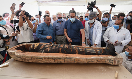 El-Enany and Waziri opening a coffin live on site