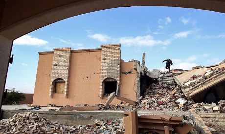 A youth climbs rubble of a destroyed building in Tawergha, Libya AFP