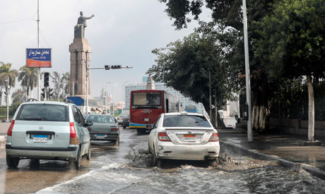 Vehicles drive after rain shower and cold weather around country in the capital of Cairo, Egypt Febr