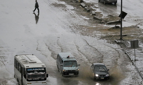 A man crosses the road during a thunderstorm and heavy rains in downtown of Cairo (Reuters)	