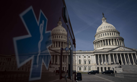 An ambulance sits parked on the plaza outside the U.S. Capitol March 16, 2020 in Washington, DC. (AF