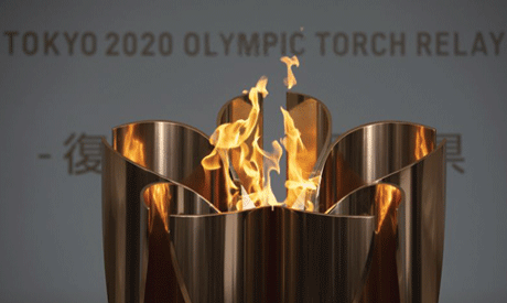 FILE - In this March 24, 2020, file photo, the Olympic Flame burns during a ceremony in Fukushima Ci